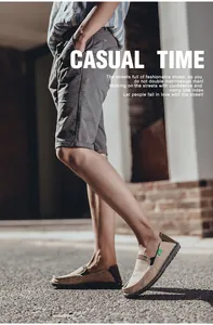 Side view of khaki canvas slip-on casual shoes with brown heel and rubber sole