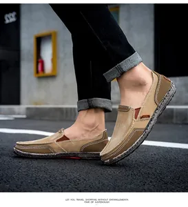 Detail of khaki men's slip-on canvas loafers showing contrast stitching on outdoor path