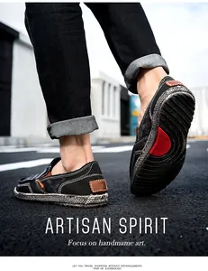 Detail of men's black canvas slip-on with white contrast stitching and woven sole