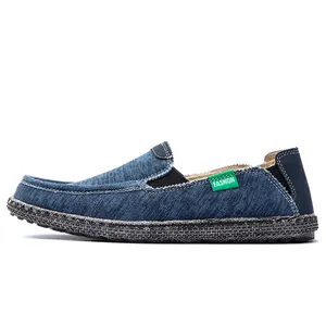 Classic navy blue men's slip-on loafers with denim texture and woven sole detail