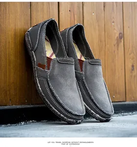 Close-up of dark grey canvas loafers with contrast stitching and jute rope sole details