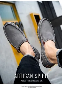 Close-up of men's dark grey slip-on canvas shoes with artisan hand-stitched detailing