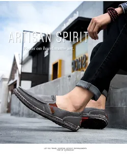 Detail of grey canvas loafer with leather stitching and woven espadrille sole detail