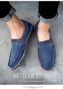 Detail of blue canvas slip-on shoe with white hand-stitching and artisan spirit texture