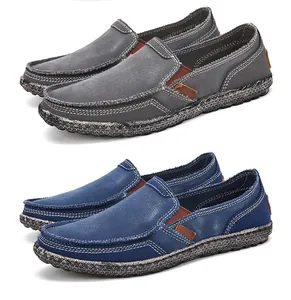 Detail of canvas slip-on loafers in grey and navy with contrast stitching and rubber soles