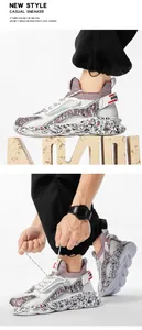 Detail of white mesh sneakers with graffiti pattern thick sole and heel strap decoration