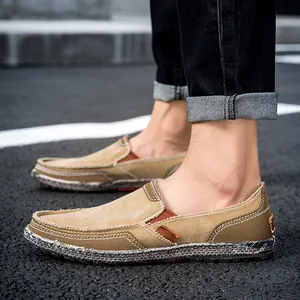 Men's khaki canvas slip-on casual shoes with double-row white stitching and rubber soles
