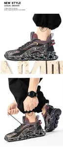 Detail of high-top sneaker with graffiti pattern and knitted collar on wavy sole
