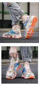 Detail of breathable mesh upper with orange cushioned sole and graffiti design