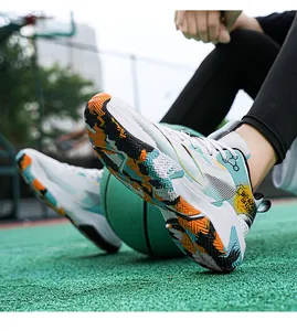 Detail view of basketball shoes with slip-resistant orange soles and graffiti side print