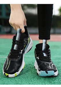 Detailed view of the breathable mesh upper and dynamic color-block sole of basketball shoes