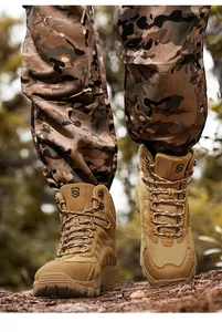 Detail of desert sand tactical boot with suede leather and camouflage pants in the wild