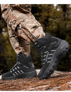 Close-up of black tactical hiking boots with non-slip rubber soles in outdoor terrain