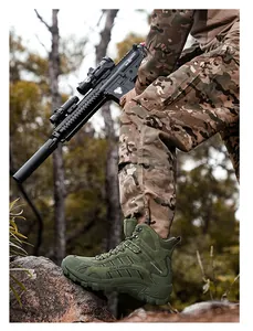 Army green tactical combat boot shown with deep tread sole on rocky outdoor terrain
