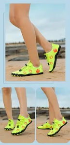 Outdoor river shoes with green mesh and orange leaf print shown on a beach setting