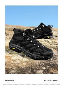 Detailed macro view of the non-slip rubber sole and suede mesh splicing of outdoor boots