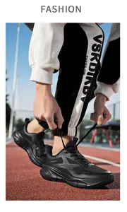 Nahaufnahme schwarzer Laufschuhe mit dicker Sohle auf einer roten Leichtathletikbahn