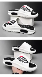 Detailed macro view of white EVA slide sandals showing cushioned massage texture and lettering