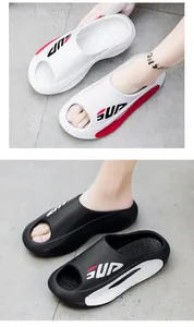Close-up of thick-soled EVA slide sandals with non-slip texture and SUP lettering
