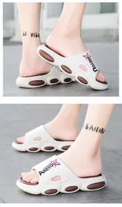 Detail view of white breathable beach slides with thick sole and fashion star logo