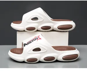 Detail of white beach slides featuring oval vents and thick cushioned sole construction