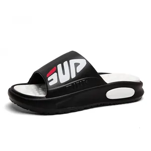 Men's sports slides with black SUP strap and white textured massage footbed on white background