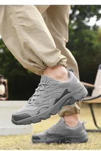 Detail of grey outdoor snow boots showing rugged anti-slip soles and layered fabric design