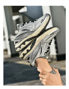 Detail of silver retro sneakers showing breathable mesh texture and cream chunky sole