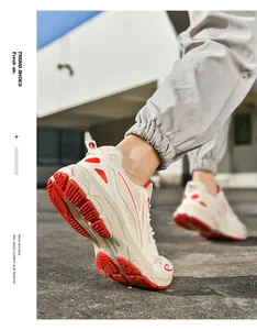 Macro view of mesh breathable fabric and red durable rubber sole of the casual sneaker
