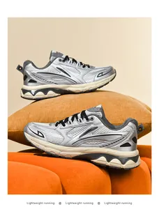 Detail of silver retro running shoe with breathable mesh on orange corduroy background