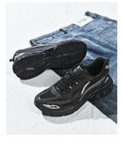 Detailed top view of black retro sneakers with breathable mesh and reflective silver lines