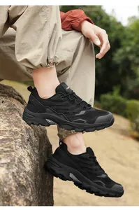 Outdoor shot of black waterproof snow boots with deep traction soles and warm lining