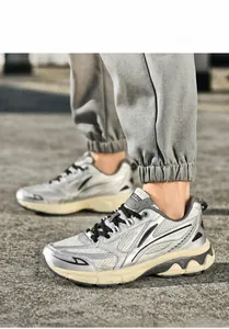 Detail of silver running sneaker featuring mesh panels and wavy cream midsoles