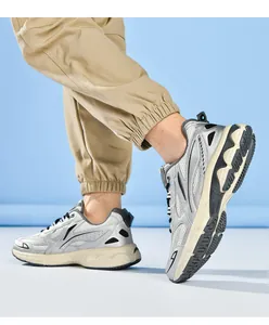Close-up of metallic silver sneakers with breathable mesh and thick cushioned soles