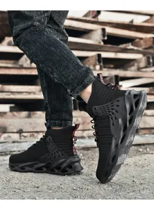 Detail of high-top safety shoes featuring hollowed soles and red safety pull tab on heel