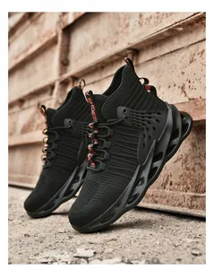 Close-up of black high-top safety shoes with breathable mesh and hollow blade sole detail