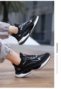Detail shot of breathable black mesh running shoes with white sport logo and cushioned sole