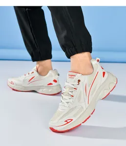 Close-up of breathable mesh fabric and fashion logo on casual white and red sneakers