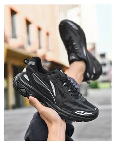 Close-up of black breathable mesh and leather paneling on stylish platform sneakers