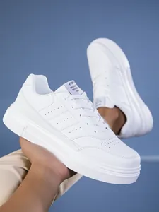 Detalle de zapatillas de cuero blanco con perforaciones y suela gruesa antideslizante