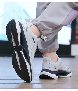 Detail of breathable grey mesh running shoes with thick slip-resistant wave soles