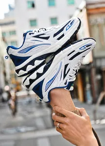 Detail of retro men's sneakers with breathable white mesh and blue leather overlays