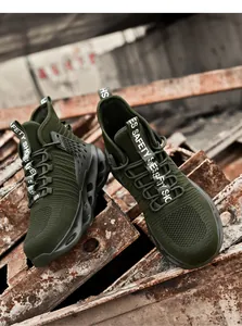 Close-up of military green safety shoes with breathable mesh and anti-slip thick soles