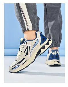 Side view of retro cream running shoes with navy blue stripes and mesh texture