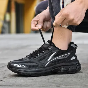 Men's casual black sneakers with breathable mesh and chunky sole in an outdoor setting