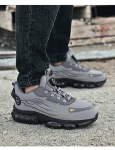 Detail of grey safety shoe with mesh fabric and a rotary buckle fastening system