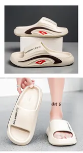 Close-up of cream EVA slippers showing thick sole, side stripes and fashion lettering