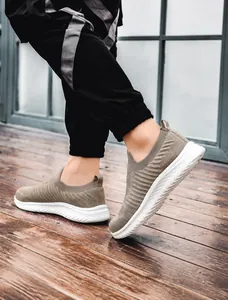 Lightweight khaki knit slip-on sneakers featuring a white ripple non-slip sole and heel pull tab