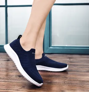 Side view of lightweight dark blue slip-on mesh shoes with white MD sole for walking