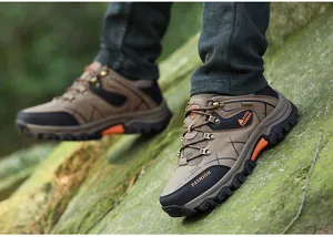 Detail of khaki outdoor hiking shoes for men with anti-slip MD sole on rocky terrain